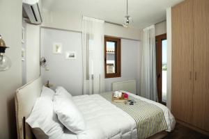 a bedroom with a white bed and a window at Cottage in Adele in Ádhele