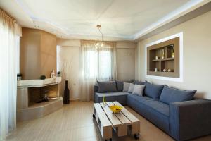 a living room with a blue couch and a table at Cottage in Adele in Ádhele
