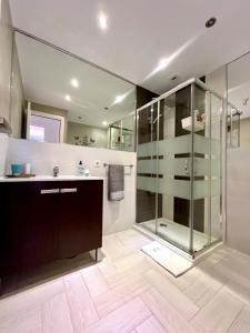 a bathroom with a glass shower and a sink at Bonito in Adeje