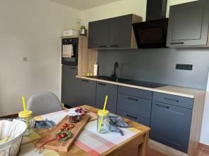 a kitchen with a wooden table with a table sidx sidx sidx at Ferienwohnung Dorfliebe in Oettersdorf