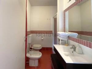 a bathroom with a toilet and a sink and a mirror at Dream Villa in Stresa in Stresa +58 photos