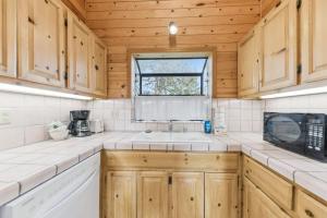 a kitchen with wooden cabinets and a sink and a microwave at 589 Danube Drive condo in Lake Valley