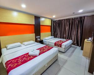 a hotel room with two beds and a window at THE STARION HOTEL BUKIT BINTANG in Kuala Lumpur