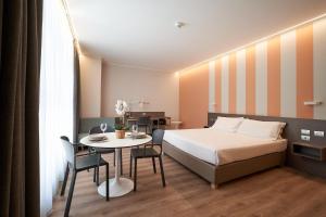 a hotel room with a bed and a table at CA' San Cristoforo in Milan