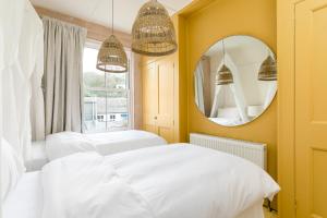 a bedroom with two beds and a mirror at no.five Flushing in Flushing