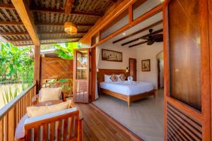 a bedroom with a bed and a balcony at The Jam Boutique Hotel in Luang Prabang +112 photos