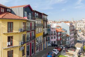 a group of buildings with cars parked on a street at City Views Flats in Historic Porto by HostWise in Porto