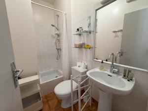 a bathroom with a sink and a toilet and a mirror at Le Clos Maréchal in Dinard +19 photos