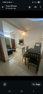 a view of a living room with a table and chairs at Evergreen Service Apartments in Kottakkal