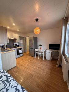 a small kitchen with a table in a room at LE FONTAINE aux portes du village avec parking in La Roche-sur-Foron