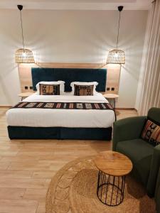 a bedroom with a bed and a couch and a table at ريف سويت للأجنحة الفندقية in Abha