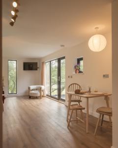 a living room with a table and chairs and a dining room at The Rising in Tongue