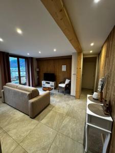 a living room with a couch and a table at Casabert T2 Glycine Quiet and harmonious in Saint-Martin-de-la-Porte +23 photos