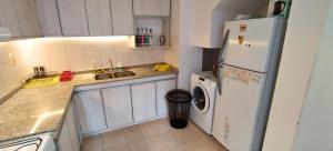 a kitchen with a refrigerator and a washing machine at Casa Xperience in Malargüe +6 photos