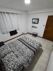 una camera da letto con un piumone bianco e nero su un letto di Alta vista Suite a Ciudad Guayana