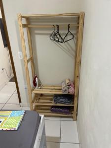 a small closet with some clothes and glasses in it at Albuquerque nro36 casa 5 in Campinas
