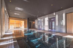 a swimming pool in the middle of a building at TERRESENS - L'Eclat des Veriaz - Megève - Praz-sur-Arly - New in Megève