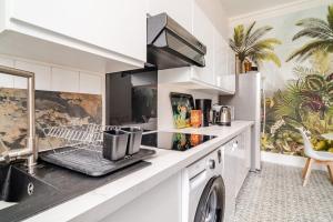 una cucina con ripiano per asciugare le stoviglie di Magnifique appartement 90 m2 à 10 minutes de Bagnoles a La Ferté-Macé Altre 15 foto