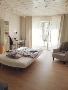 a bedroom with a bed and a chair and a window at Dein Zimmer bei der Spree in Berlin