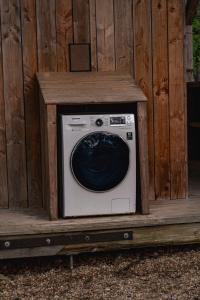 a washing machine sitting on a wooden platform at Chrysalide in Varen
