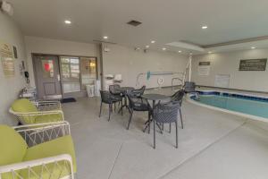 a pool room with a table and chairs next to a pool at Hampton Inn & Suites-Florence Downtown in Florence