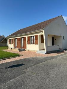a house with a driveway in front of it at Maison cosy à Moyvillers classée de tourisme 3 étoiles in Moyvillers