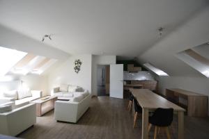 a living room with white furniture and a table at Budget Flats Brussels in Brussels
