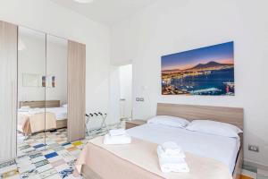 a bedroom with two beds and a painting on the wall at Appartamenti La Dimora di Parthenope Centro Storico in Naples