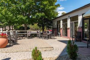 a patio with chairs and tables outside of a building at Hampton Inn Portsmouth Central in Portsmouth