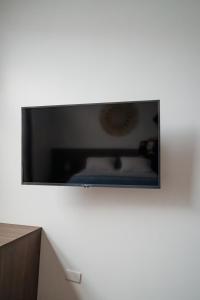 a flat screen tv on a white wall at Casa Grace Olón in Olón