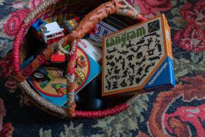 un panier rempli de jouets sur un tapis dans l'établissement Grove Den I Heerlijk vakantiehuis met bosrijke tuin, à Nunspeet