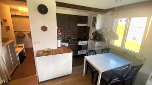 a kitchen and dining room with a table and a clock at Studio Alpenhaus in Bettmeralp