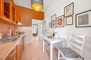 a kitchen with a white table and a white chair at Waterfront River Side Roof Top Apartment - Terrace with city view in Prague