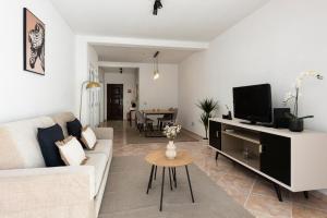 a living room with a couch and a tv at NUZZA - Vilamoura Marina with BBQ in Vilamoura +15 photos