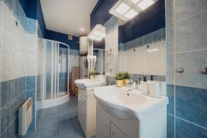 a bathroom with two sinks and two toilets at Waterfront River Side Roof Top Apartment - Terrace with city view in Prague +56 photos