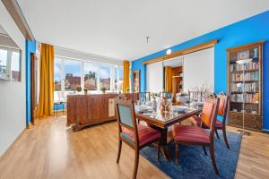 a dining room with a table and chairs at Waterfront River Side Roof Top Apartment - Terrace with city view in Prague