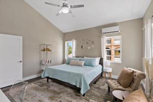 a bedroom with a bed and a ceiling fan at The Queen's Quarters - King Bed - AC - Walkable in Christiansted