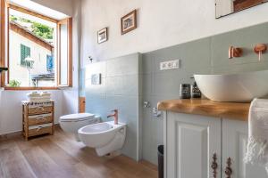 a bathroom with a sink and a toilet at Casa con terrazza panoramica sul lago Maggiore in Maccagno con Pino e Veddasca +30 photos