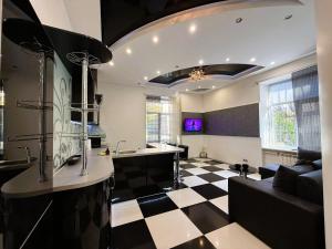 a kitchen with a black and white checkered floor at Kyiv Kingdom Apartments in Kyiv