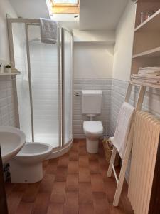 a bathroom with a shower and a toilet and a sink at La Fattoria in Santarcangelo di Romagna