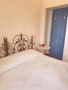 a bedroom with a bed and a blue door at La Fattoria in Santarcangelo di Romagna