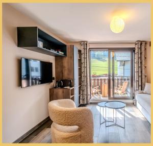 a living room with a couch and a table at La Petite Ourse I Studio meublé Bernex in Bernex