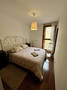 a bedroom with a bed and a window at Casa exclusiva l Chimenea l Wifi l Garaje l Pool in Biescas