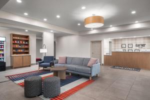 a waiting room with a couch and two chairs at Garner Hotel Paducah West in Paducah