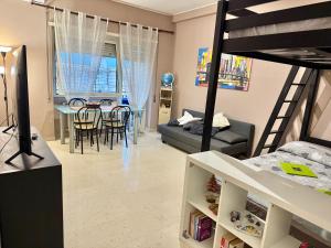 a bedroom with a bunk bed and a dining room at Stura Home in Rome