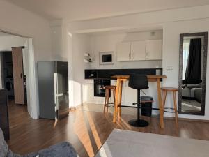 a kitchen and living room with a table and a refrigerator at 1A Wohntraum in Graz