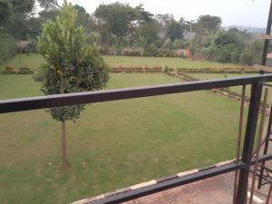 a view of a garden from a balcony at Sabr resort hotel in Wakiso