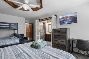 a bedroom with a bed with a ceiling fan and a dresser at Just Like Home #15:Moore 5bd,4ba w/pool & hot tub in Moore +37 photos