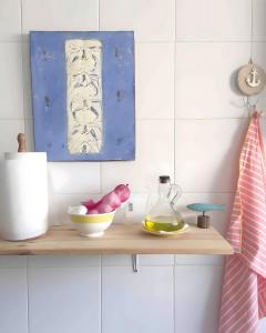 a shelf with a bowl and a bottle on it at Jávea Beachfront Penthouse in Platja de l'Arenal