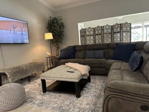 a living room with a couch and a table at Newly Renovated Villa with Hot Tub in Fort Lauderdale